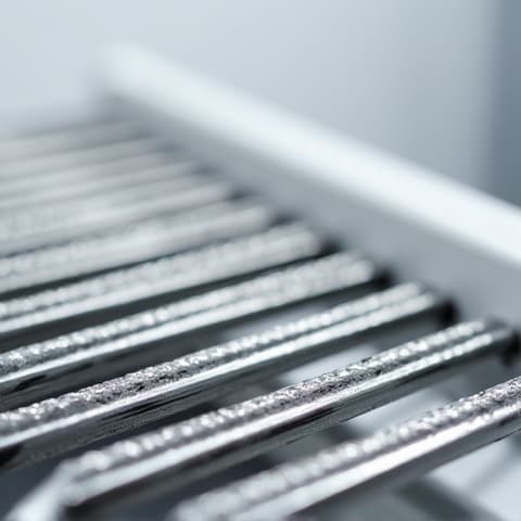 Sealed System Evaporator Repair Sacramento. Technician focusing on the evaporator coils within a refrigerator